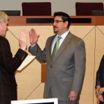 Assemblymember Roger Dickinson swears in Phil Serna who is accompanied by Roxanna Recinos-Serna.