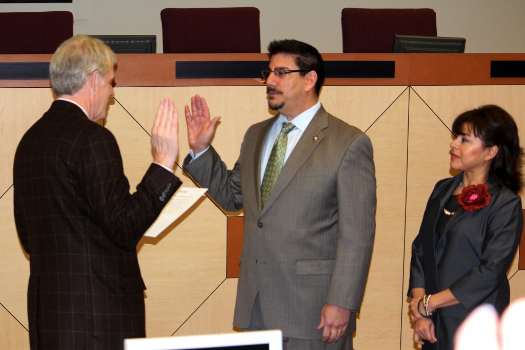 Assemblymember Roger Dickinson swears in Phil Serna who is accompanied by Roxanna Recinos-Serna.