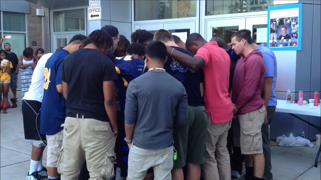 Inderkum football players past and present unite in prayer for Dylan Akins.