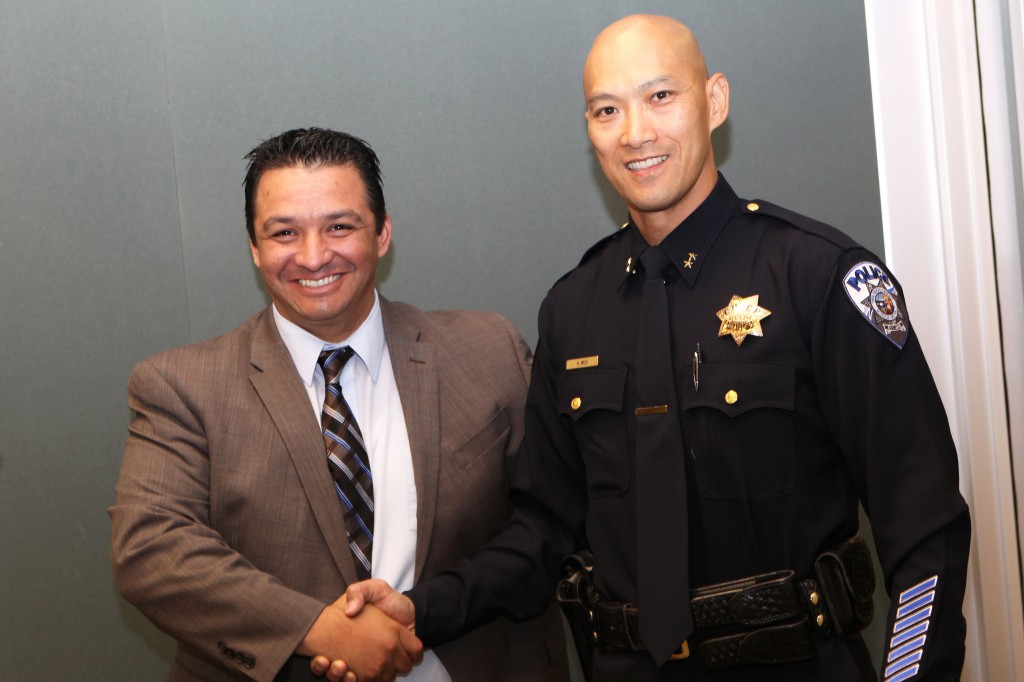 Twin Rivers USD Superintendent Dr. Steven Martinez, left, congratulates Harvey Woo, right, the district’s new police chief.