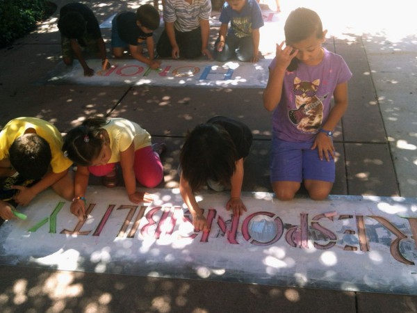 Youngsters chalk "Responsibility" during a Values Project workshop held at Kids Kamp in south Natomas last month. Stencils and chalk will be available for children to chalk in a closed off parking lot at Celebrate Natomas on Sept. 7.