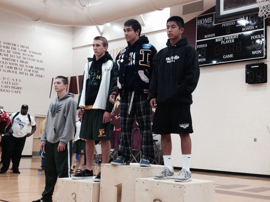 Ruben Escalante, Inderkum senior at 126 pounds, stands on the podium as the Sac-Joaquin Section Division III champion on Saturday at Whitney High School in Rocklin. / Photo: T. Horn