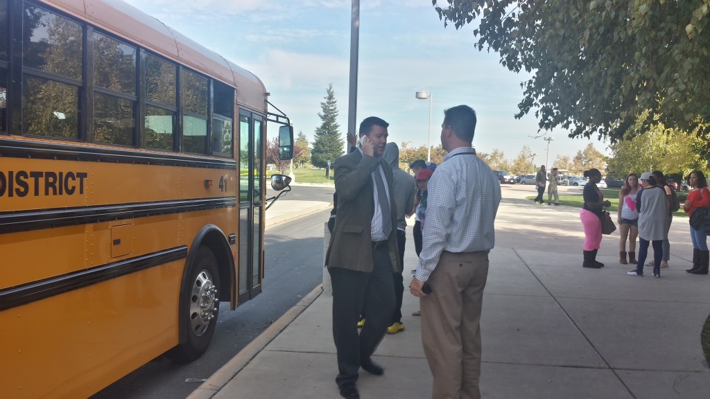 School officials communicate with each other during the district-wide earthquake safety drill.