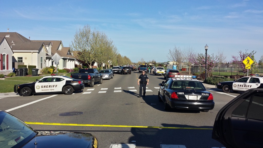 Multiple law enforcement agencies have blocked off streets adjacent to home where suspect is hiding. / Photo: Marc Laver NatomasBuzz.com