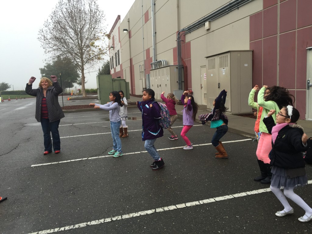 Principal Jennifer Kloczko gets her groove on with Star Academy students every morning in the car loop. / Photo: J. Mock