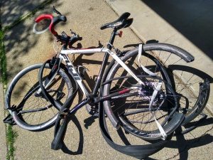 Image of bicycle with bent and broken wheel frames and tires.