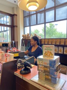 Image of person at a cash register ringing up an order.