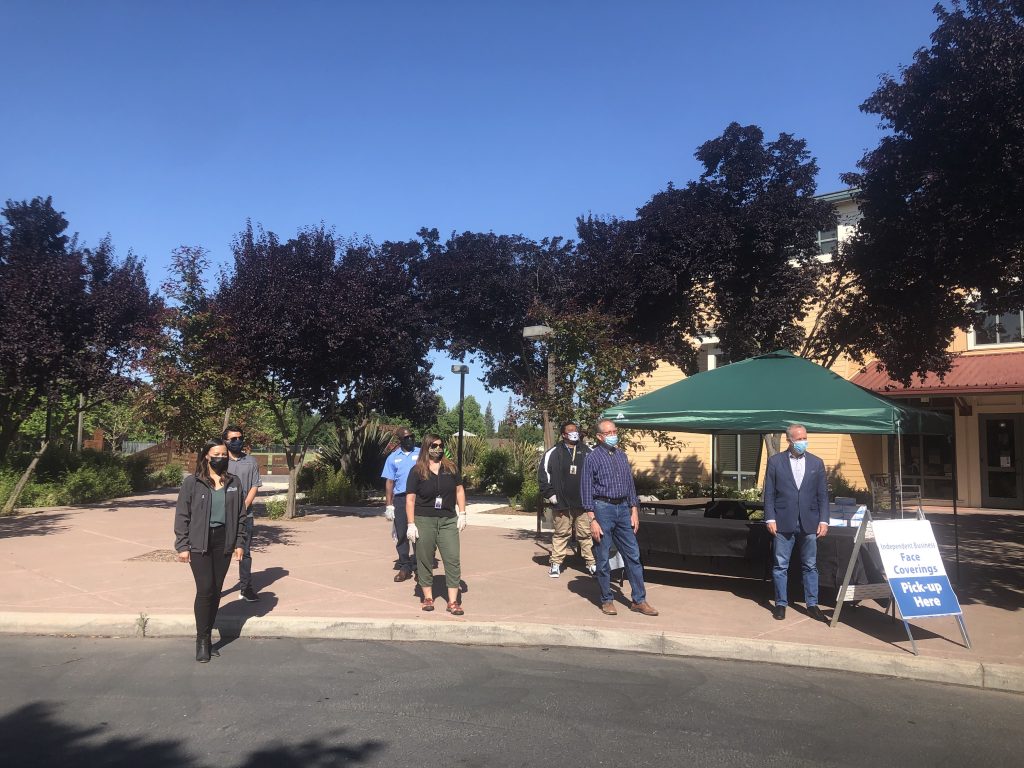 Image of pop up tent where people are lined up.