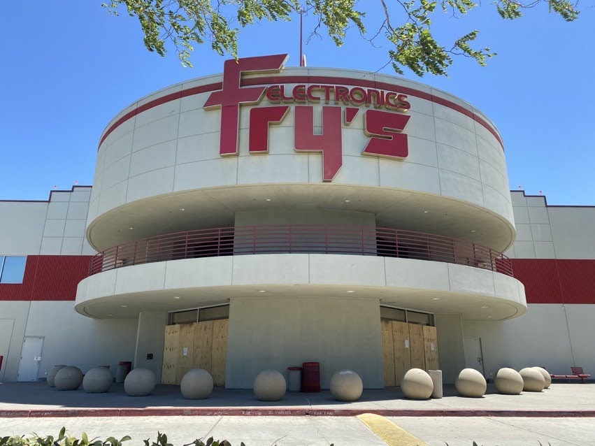 Image of Fry's Electronics storefront with boards covering what would be the entrance doors.