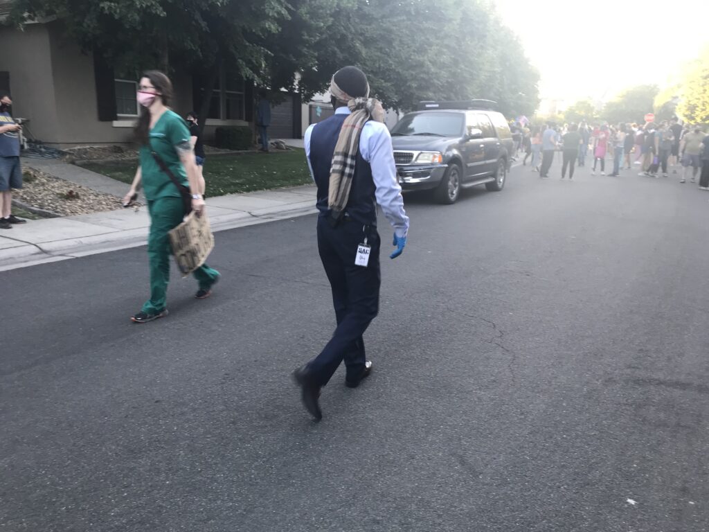Image of man walking toward crowd.