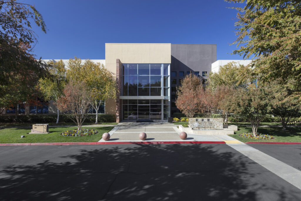 Image of office building with trees on both sides.