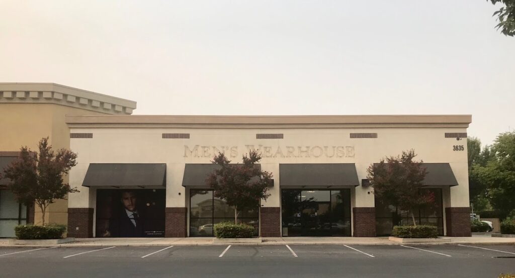 Image of former Men's Wearhouse building in Natomas. An outline of the store's name is visible on the building.
