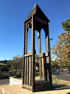 Image of wooden tower with a steeple.