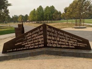 Image of metal sculpture with silhouette of words cut out.