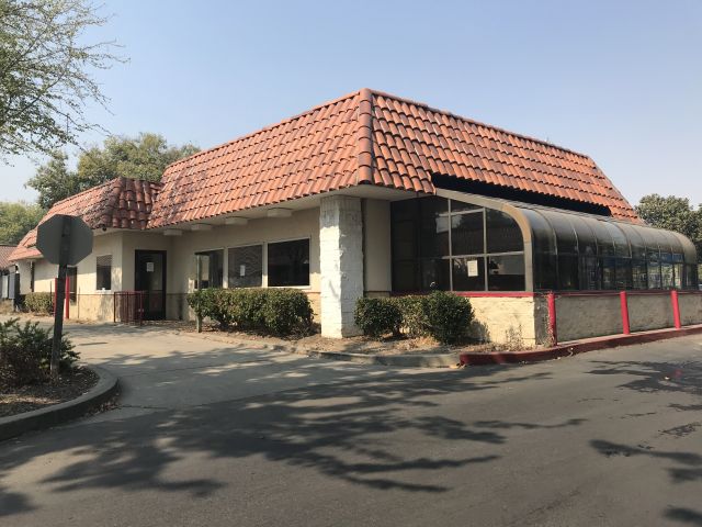 Image of vacant restaurant with a drive-thru window.