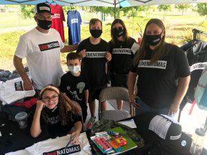 Image of several people wearing LOVE NATOMAS shirts.