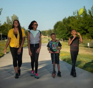 Image of two women walking on a Natomas trail with two children.