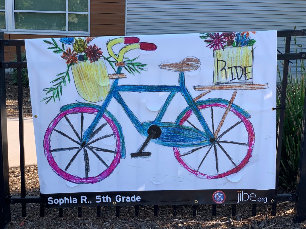 Image of banner of bicycle with basket full of flowers.