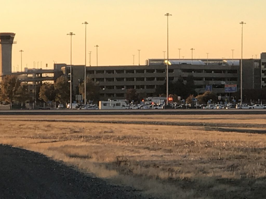 Image of airport in distance. Emergency lights barely visible.