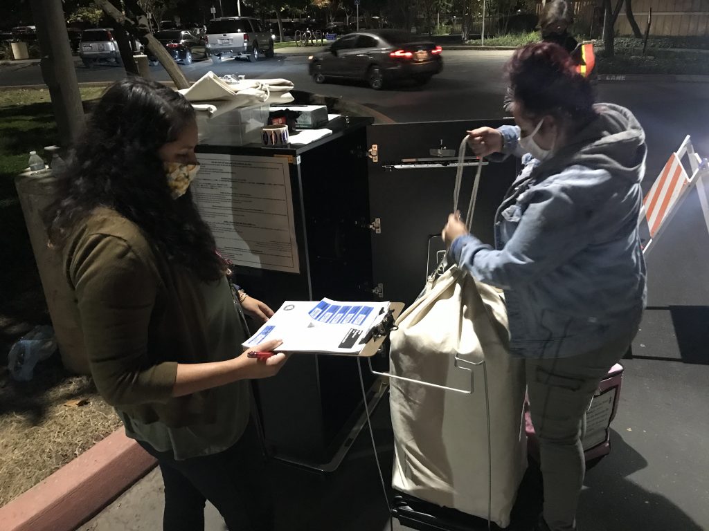 Image of county employees collecting ballots at the South Natomas Library.