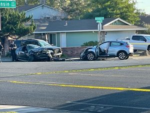 Image of three damaged vehicles. Yellow police tape is visible in the foreground.