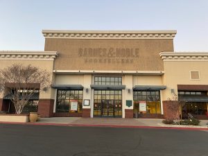 Image of large, empty building. On the front, you can see the outline of the words Barnes & Noble Booksellers which have been removed.